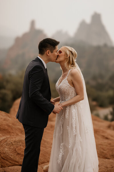 Bride and groom share first kiss during Garden of the Gods Colorado Springs elopement.