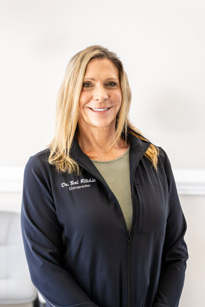 Dr. Tori posing for a mug shot