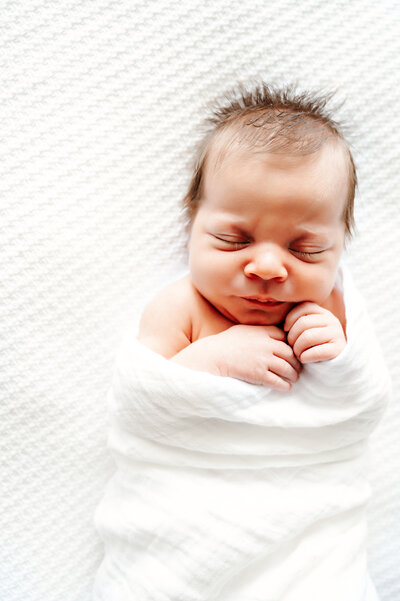 newborn baby in swaddle wrap