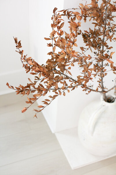 Fall plants in a white flower vase