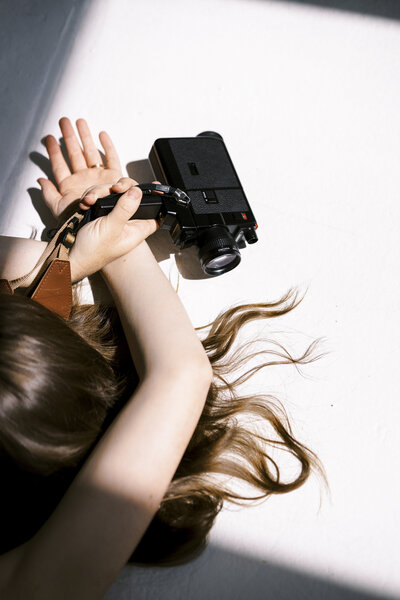 woman holding video camera