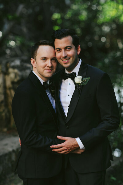 Grooms posing for a portrait at their Luxury Miami Destination Elopement at Vizcaya
