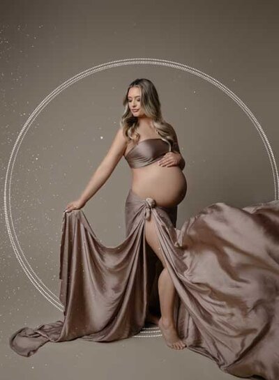 Fine art maternity portrait of pregnant mom tossing draped fabric. Photo taken by Jenni Nikki net at Atlanta photography studio in Woodstock, GA.