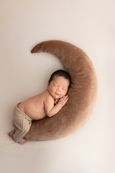 baby sleeping on moon