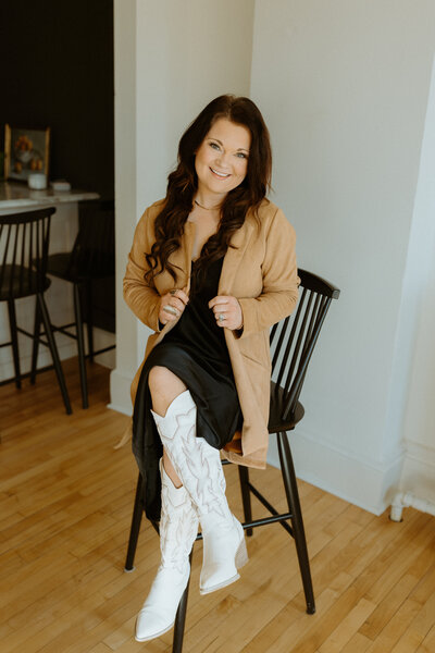 Woman sitting in a chair smiling at camera 