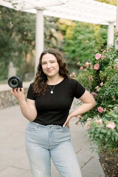 photographer sitting on the ground pretending to take a picture taken by spokane family photographer