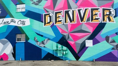 Painted mural of a heart with "Denver" painted by Denver artist supporting mental health