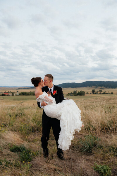 Rylie holding Tayhgen at their Belle Fourche wedding.