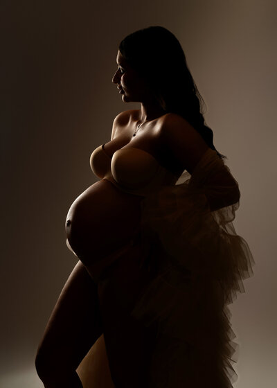 Rim lit maternity photo captured in Syracuse studio