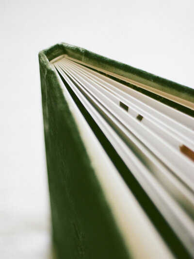 Closeup of Fauna & Film's Bespoke Heirloom Albums with linen and velvet covers.