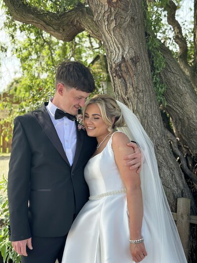 Bride and groom naturally smiling at each other