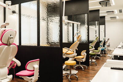 pediatric dentist office exam room with colorful chairs and black room dividers