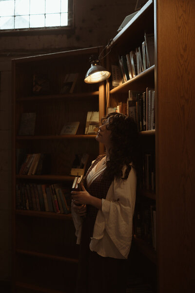 woman reading a book in a library