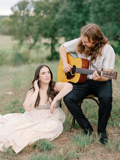 Mikaela Kahn live wedding vocalist sitting next to her husband while he plays a guitar