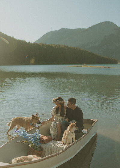 couple in boat with their dogs