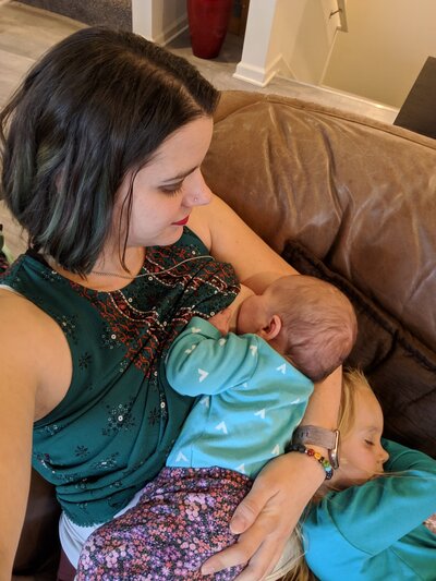 Julie Pokorny nursing her 2nd baby successfully after baby received craniosacral therapy and a tongue tie release. 