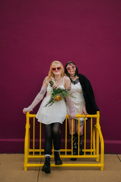 Tattooed couple sharing a candid moment during their alternative wedding in Springfield, MO, photographed by Chelsea Stanford.