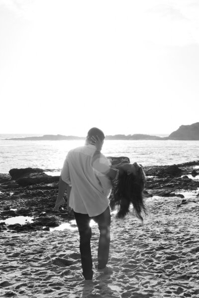 black and white engagement photo laughing couple