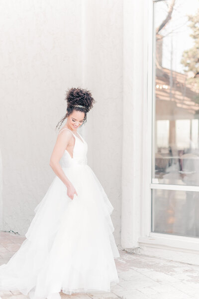 a cheerful bride spinning her dress for a beautiful must have bridal portrait at the sweetheart winery posing or wedding photography in colorado