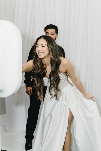 Bride using a digital photo booth at wedding