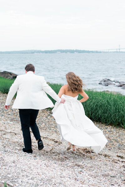 Newport Wedding Photographer | Rhode Island Caprio Captured Photography | Bride and Groom Smiling At Each Other With Pink With A Pink And White Florals
