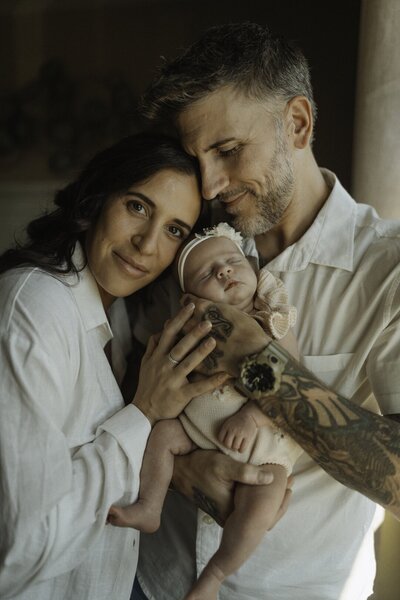 mom and dad close up with newborn baby girl- boho style
