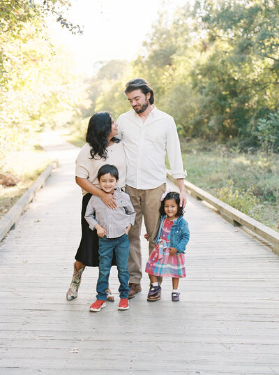 Photographers, Radhika and Ian, hold hands and walk through a park