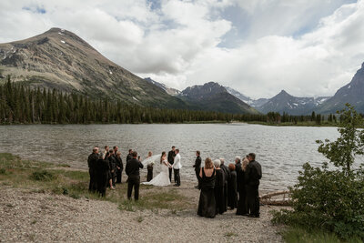 A black and white photo of a couple kissing during their elopement in Glacier National Park.