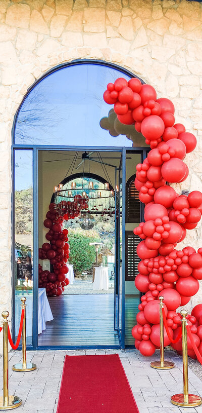 Luxury gold balloon installation with metallic spheres and star-shaped balloons creating a glam photo backdrop for Arizona events and parties.