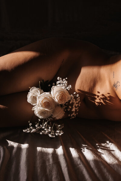 Female body in artistic form with flowers