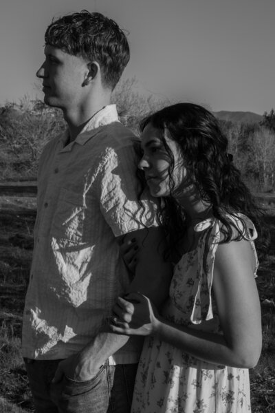 Elizabeth holding on to David's arm, while they gaze forward, in black and white.