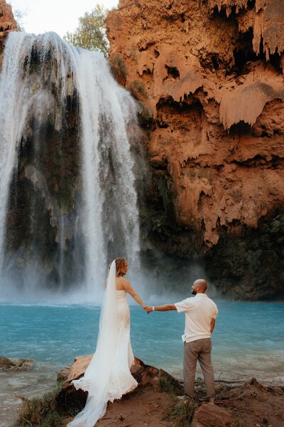 Couple exchanging vows on a mountaintop in Utah at sunset.