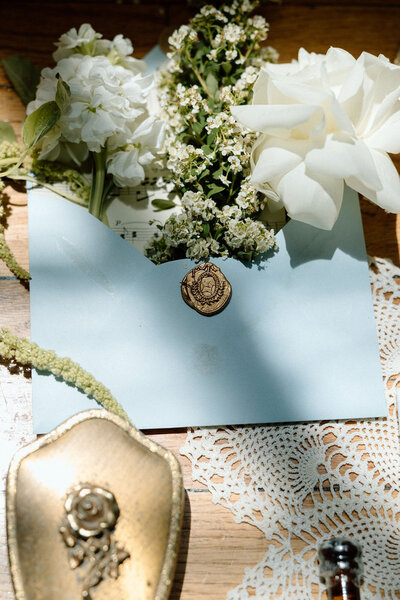 Floral centerpieces in cowboy boots on a white table