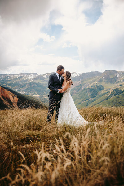 Couple shares a kiss after their mountaintop elopement in Ouray, Colorado.