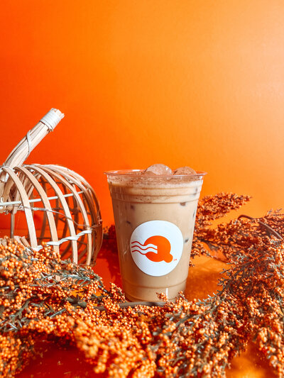 Glass of iced cucumber latte with latte art and fresh cucumber garnish – Quigley Coffee Co handcrafted specialty coffee.