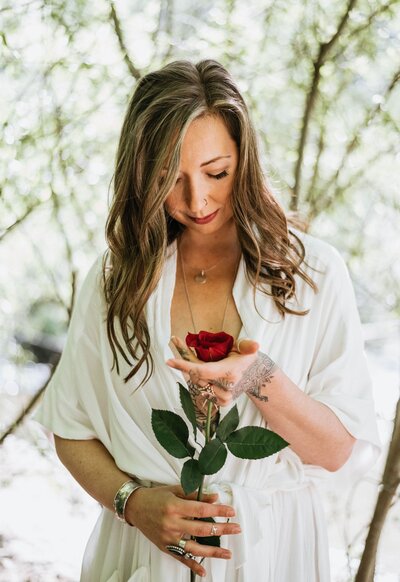 Shae Savage holding a bright red rose