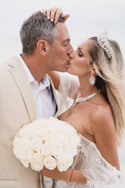 Bride and groom kissing at the beach in Miami photographed by Fort Myers wedding photographer