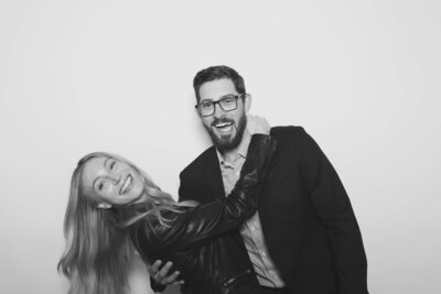 A couple hugs and smiles at the camera, representing an image taken by the Birdie Booth, an Eugene photo booth for weddings.