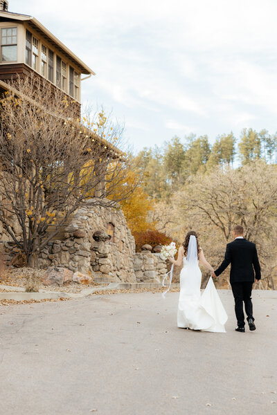 Thomas and Avalon walking to the State Game Lodge at their Custer State Park Wedding.