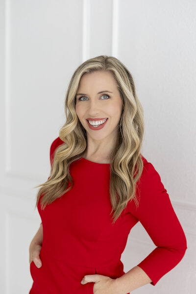 Smiling image of Dr. Maren Locke in a red dress