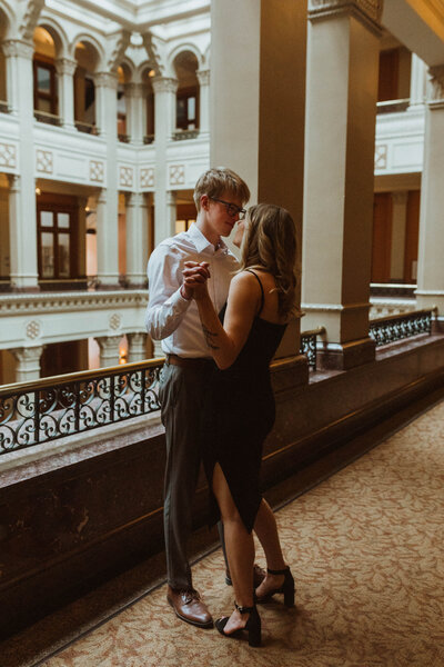 A modern, classy winter engagement session in Minneapolis, Minnesota exploring  the halls of a historical  landmark center