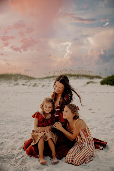 young girl laying in her mother's lap.