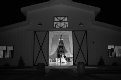 Bride and groom dancing in a barn