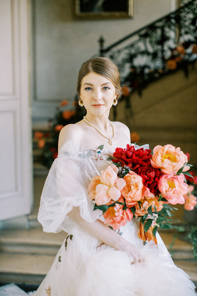 A bridal portrait during a Galveston Wedding. Bride is holding a red bouquet. 