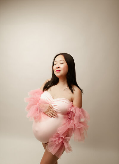 Elegant pregnancy photo of a woman in a classic studio setting in Minnesota