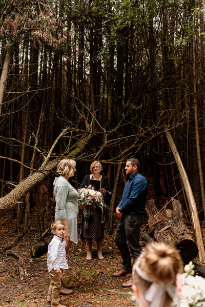 Couple exchanging vows surrounded by family in Guelph