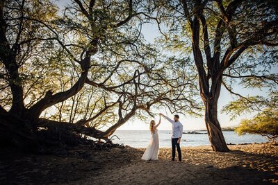 couple dancing under the trees during big island elopement