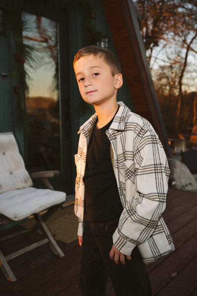 Outdoor lifestyle portrait of a young boy during a family photo session in Cold Spring, New York