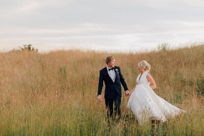 wedding-couple-walking-through-long-grass