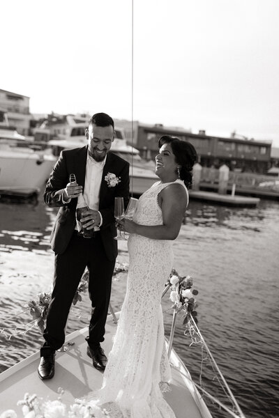 Bride and groom on a sailboat in Long Beach, California for their luxury elopement photographed by a wedding photographer based in Denver and available worldwide.